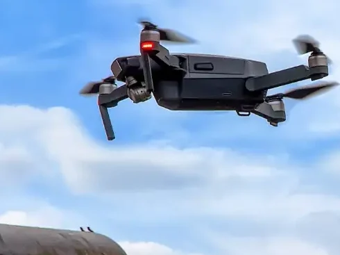Inspection drone hovering above a residential roof
