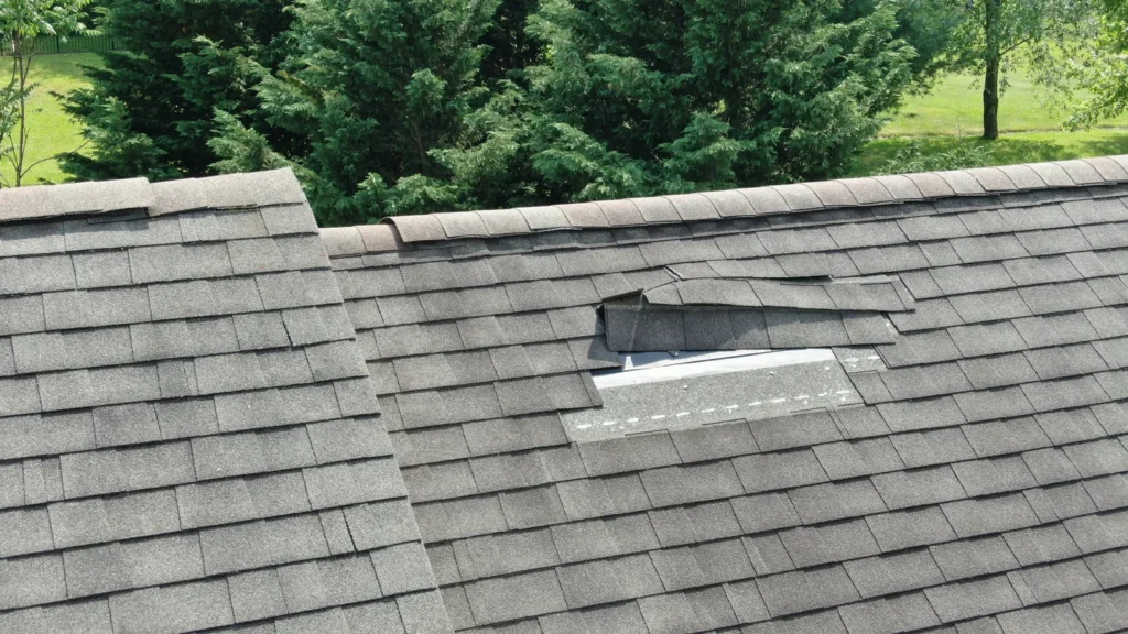 Drone photograph of missing asphalt shingles on a residential roof
