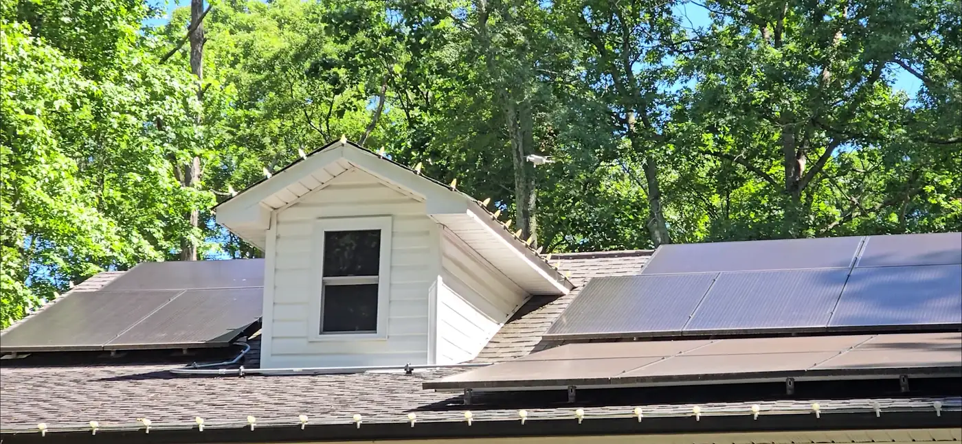 Drone view of a roof with a dormer and solar panels during a Home Inspection Carolina roof inspection