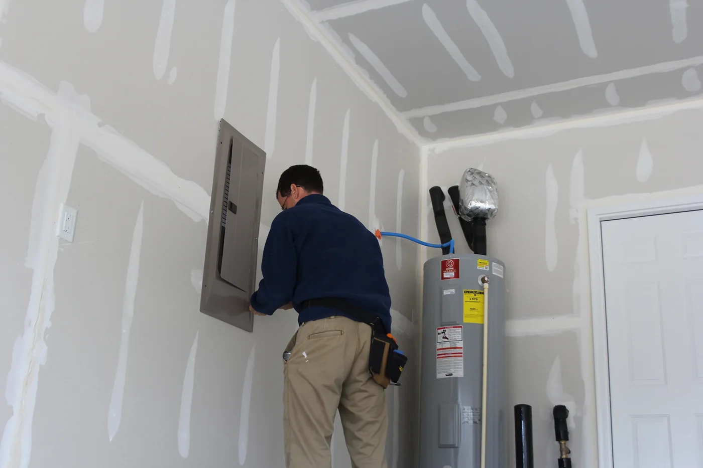 Home inspector opening an electrical panel