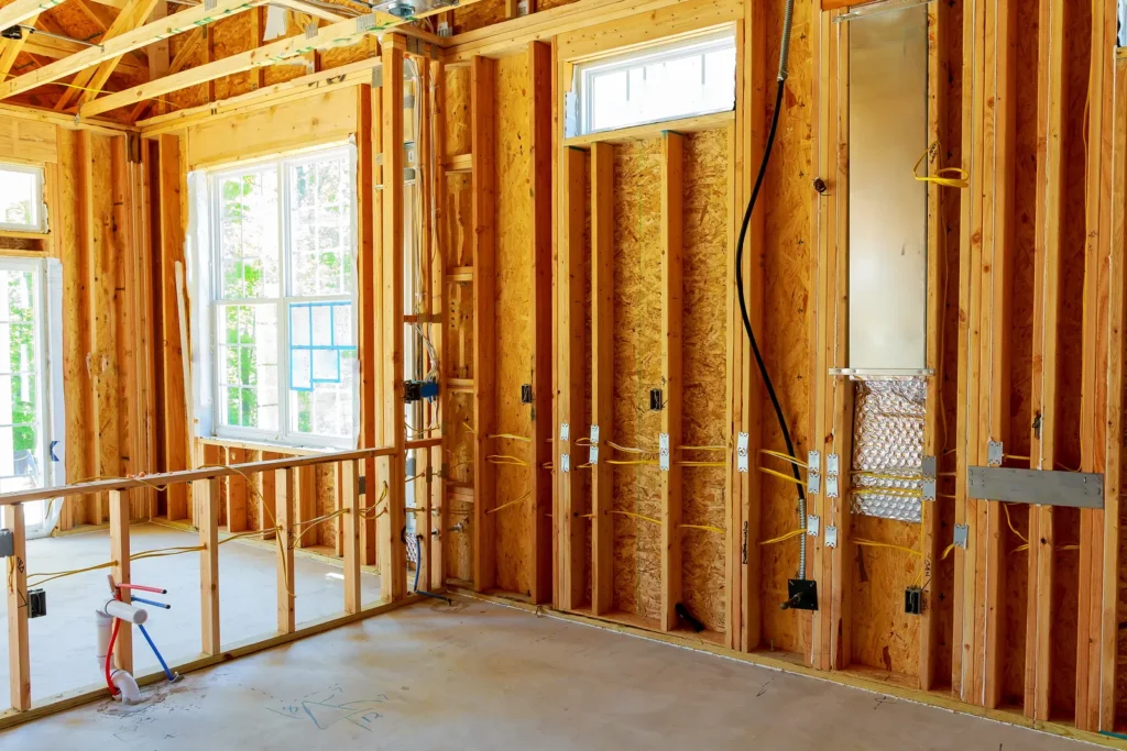 Framed interior walls with electrical and plumbing rough-in before drywall